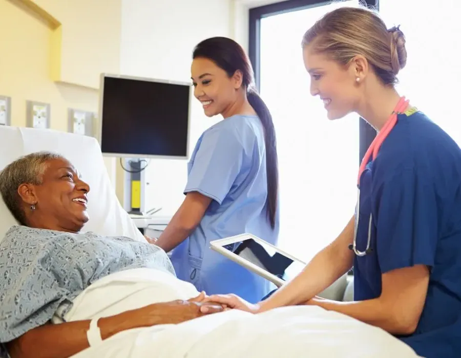 CVICU Cardiac Nurse Speaking with Patient in Hospital Bed